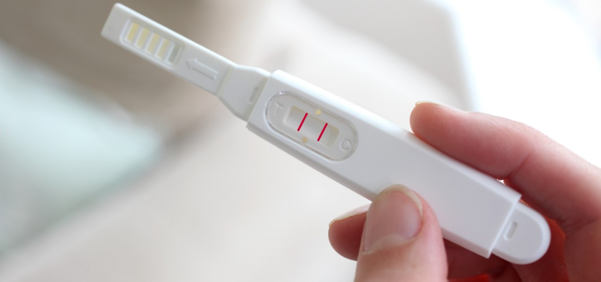Woman holding a pregnancy test device